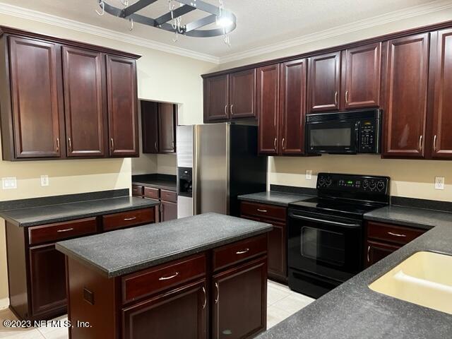 3121 East Banister Road St. Augustine, FL 32092 - Photo 8 of 31 a kitchen with granite countertop wooden cabinets and stainless steel appliances