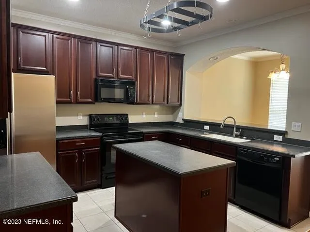 a kitchen with a sink a stove and cabinets