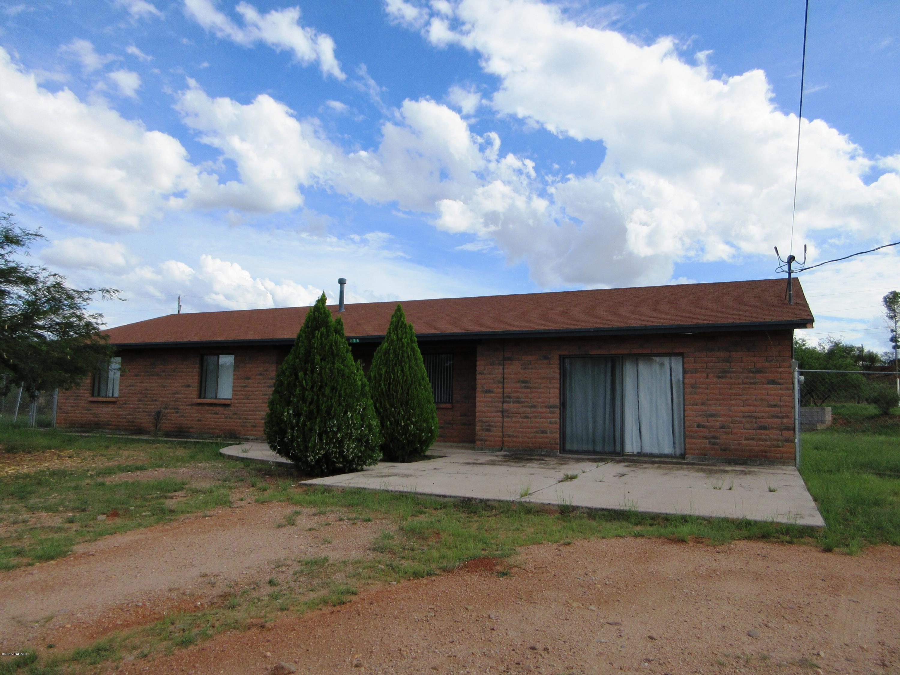 876 Calle Zapotec Rio Rico, AZ 85648 - Photo 1 of 29 a view of a wooden house with a yard