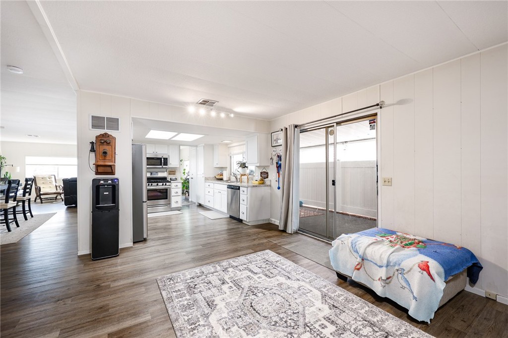 1120 East Mission Road, Unit 79 Fallbrook, CA 92028 - Photo 12 of 43 a spacious bedroom with a bed and a view of kitchen