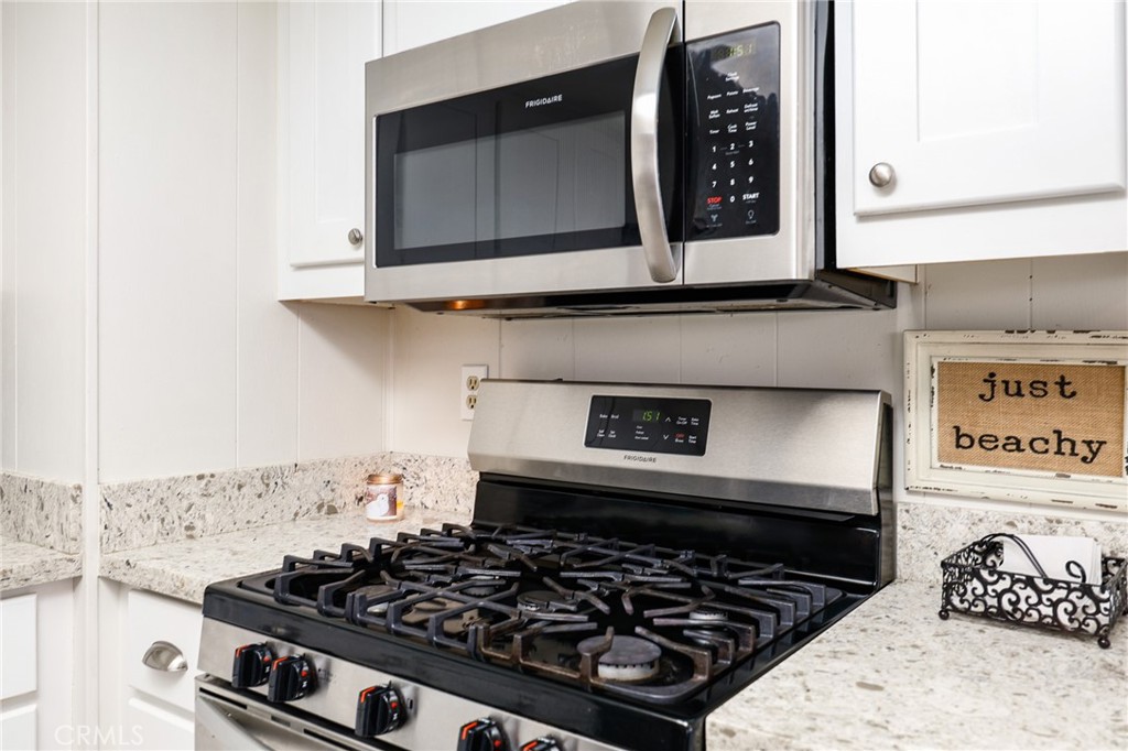 1120 East Mission Road, Unit 79 Fallbrook, CA 92028 - Photo 16 of 45 a kitchen with a stove and a microwave