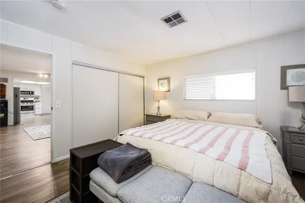 a bedroom with a bed and a mirror