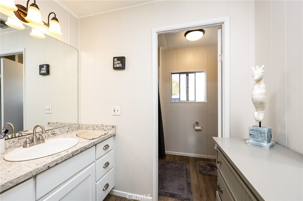 1120 East Mission Road, Unit 79 Fallbrook, CA 92028 - Photo 19 of 43 a spacious bathroom with a granite countertop sink and a mirror