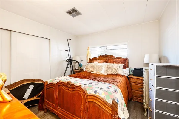 a bedroom with a bed and a closet