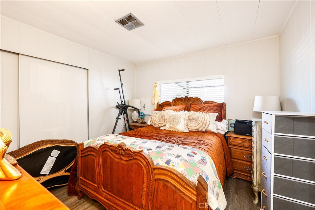 1120 East Mission Road, Unit 79 Fallbrook, CA 92028 - Photo 20 of 43 a bedroom with a bed and a closet