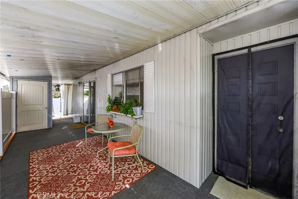 a living room with furniture a rug and a window