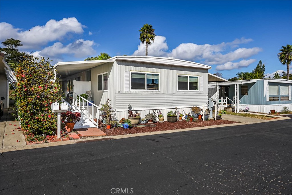 1120 East Mission Road, Unit 79 Fallbrook, CA 92028 - Photo 3 of 43 a front view of a house with a yard