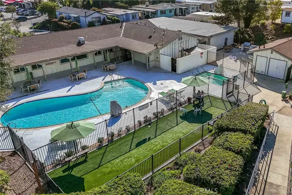 an aerial view of a house with swimming pool and patio