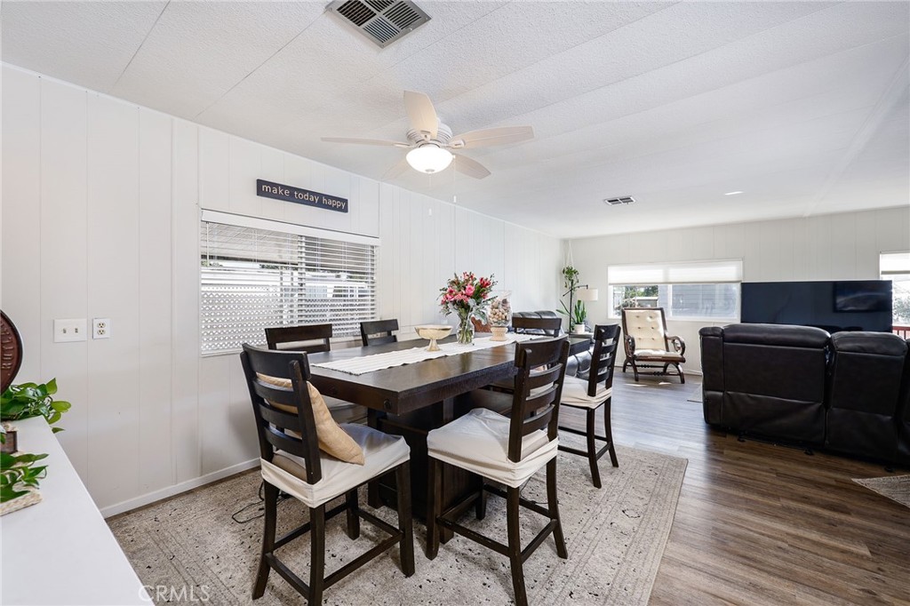 1120 East Mission Road, Unit 79 Fallbrook, CA 92028 - Photo 9 of 43 a view of a dining room with furniture and wooden floor