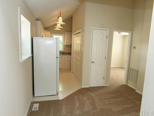 715 Edmund Street Raleigh, NC 27604 - Photo 5 of 13 a view of a kitchen with a refrigerator and a sink