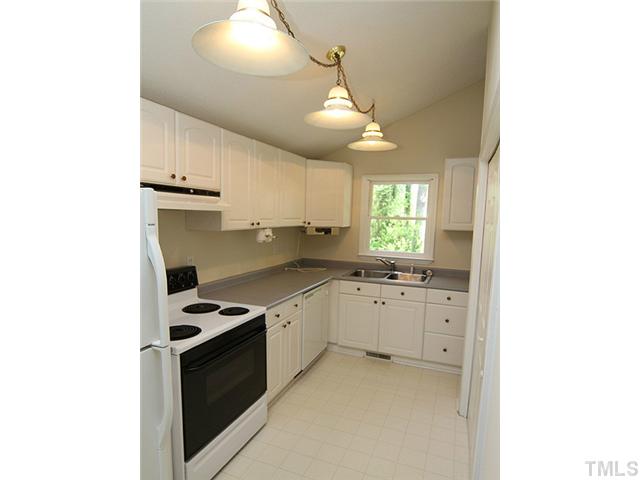 715 Edmund Street Raleigh, NC 27604 - Photo 6 of 13 a kitchen with granite countertop a stove a sink and a refrigerator