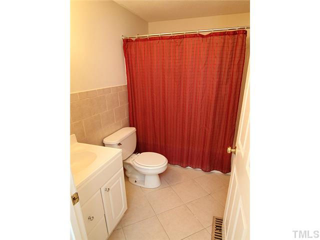 715 Edmund Street Raleigh, NC 27604 - Photo 9 of 13 a bathroom with a toilet a sink and a mirror