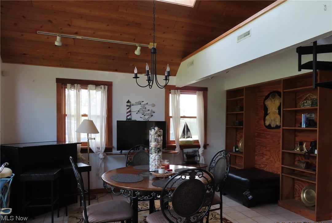 182 Harcourt Road Vermilion, OH 44089 - Photo 11 of 29 Tiled dining space with track lighting, a healthy amount of sunlight, lofted ceiling, and wooden ceiling