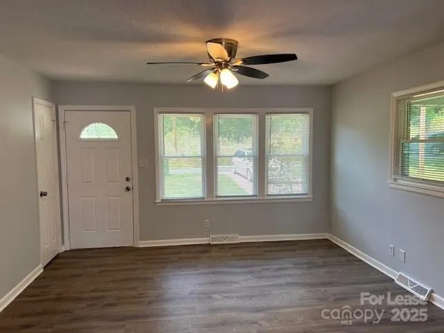 a view of room with window and wooden floor