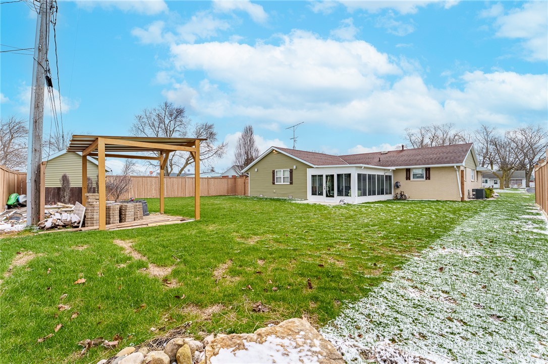 305 South Vandemark Road Sidney, OH 45365 - Photo 7 of 32 This spacious backyard offers a perfect setting for outdoor enjoyment and potential relaxation.