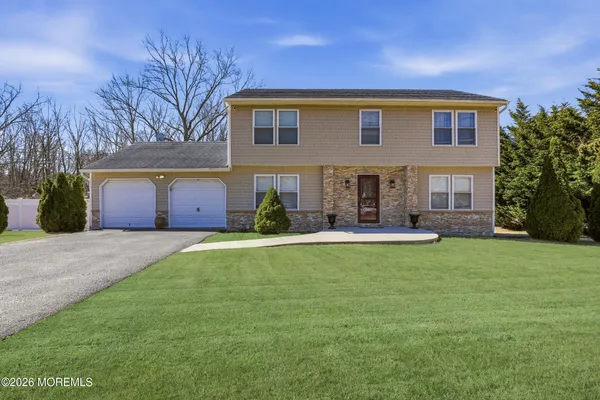 a front view of house with yard and outdoor seating