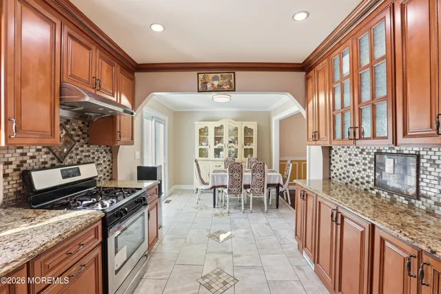 a kitchen with stove and cabinets