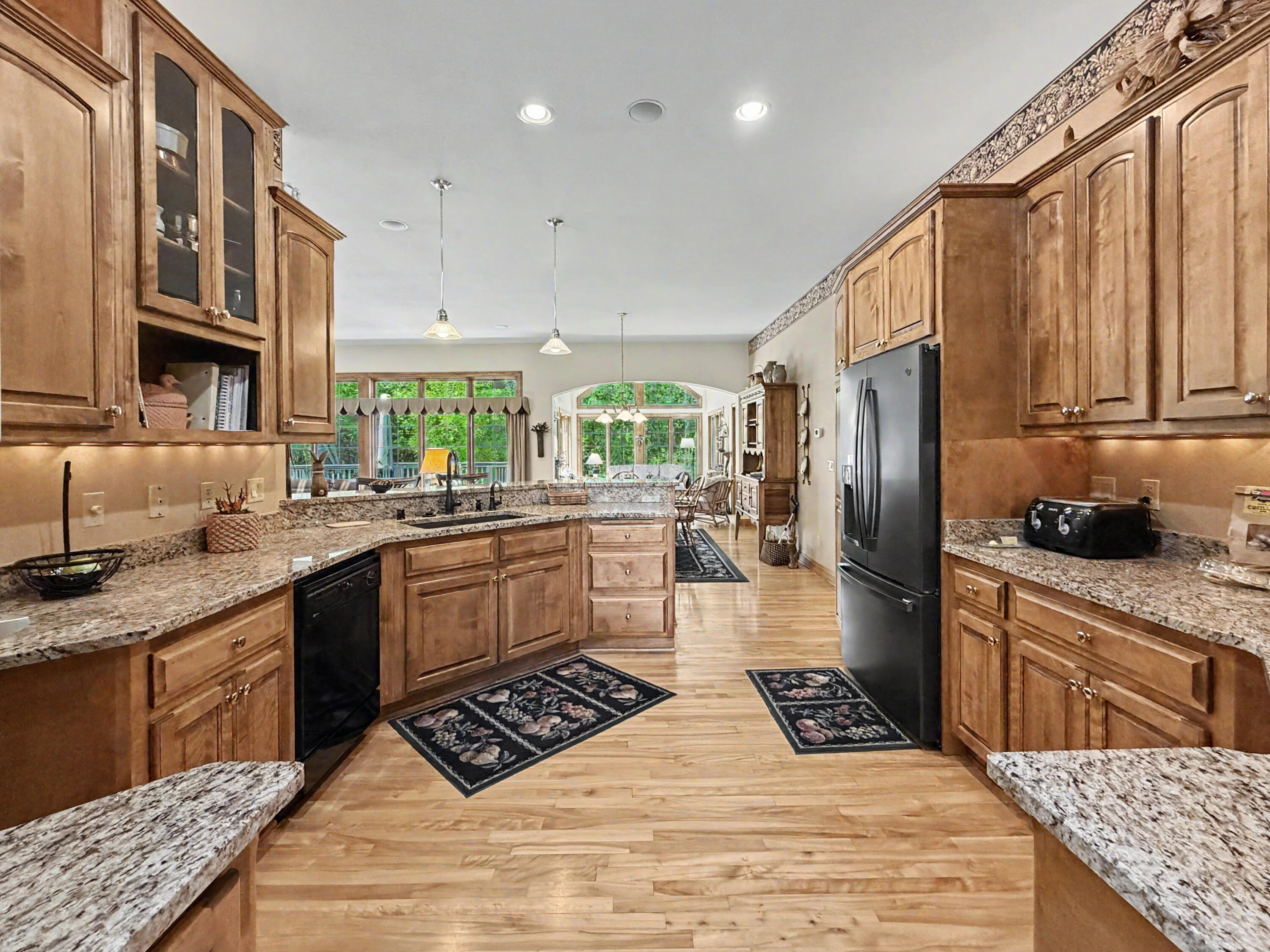 W291-s5245 Ridgefield Road Waukesha, WI 53189 - Photo 10 of 44 The expansive kitchen features rich Birch cabinetry, Birch floors, granite countertops, a gas cooktop, large center island, and abundant storage and workspace.