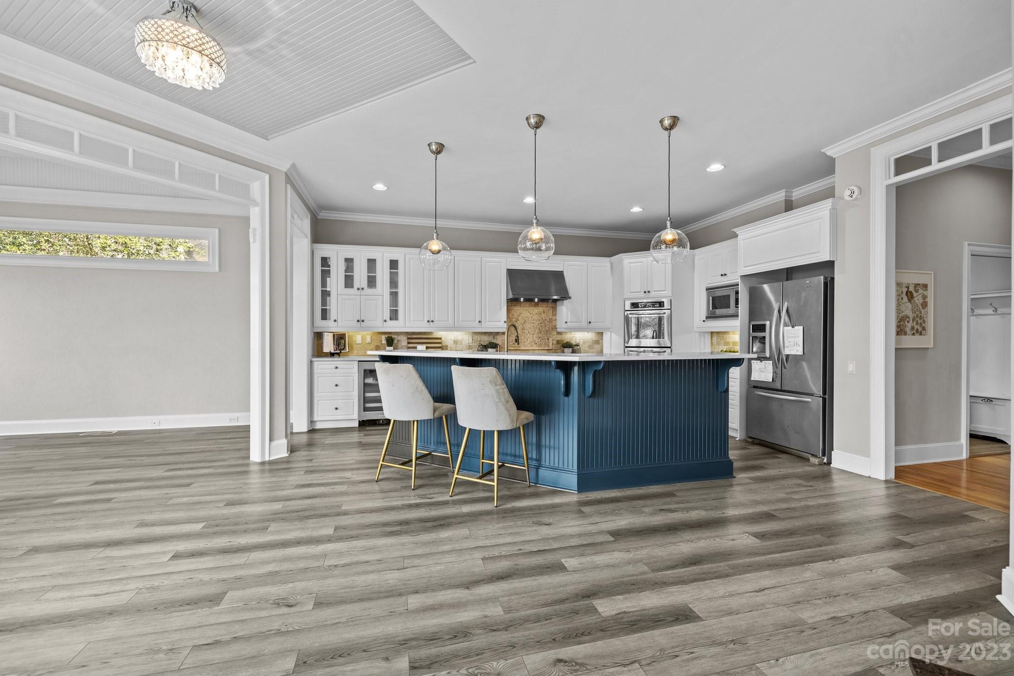4732 Old Course Drive Charlotte, NC 28277 - Photo 19 of 48 a kitchen with stainless steel appliances kitchen island a refrigerator and a wooden cabinets