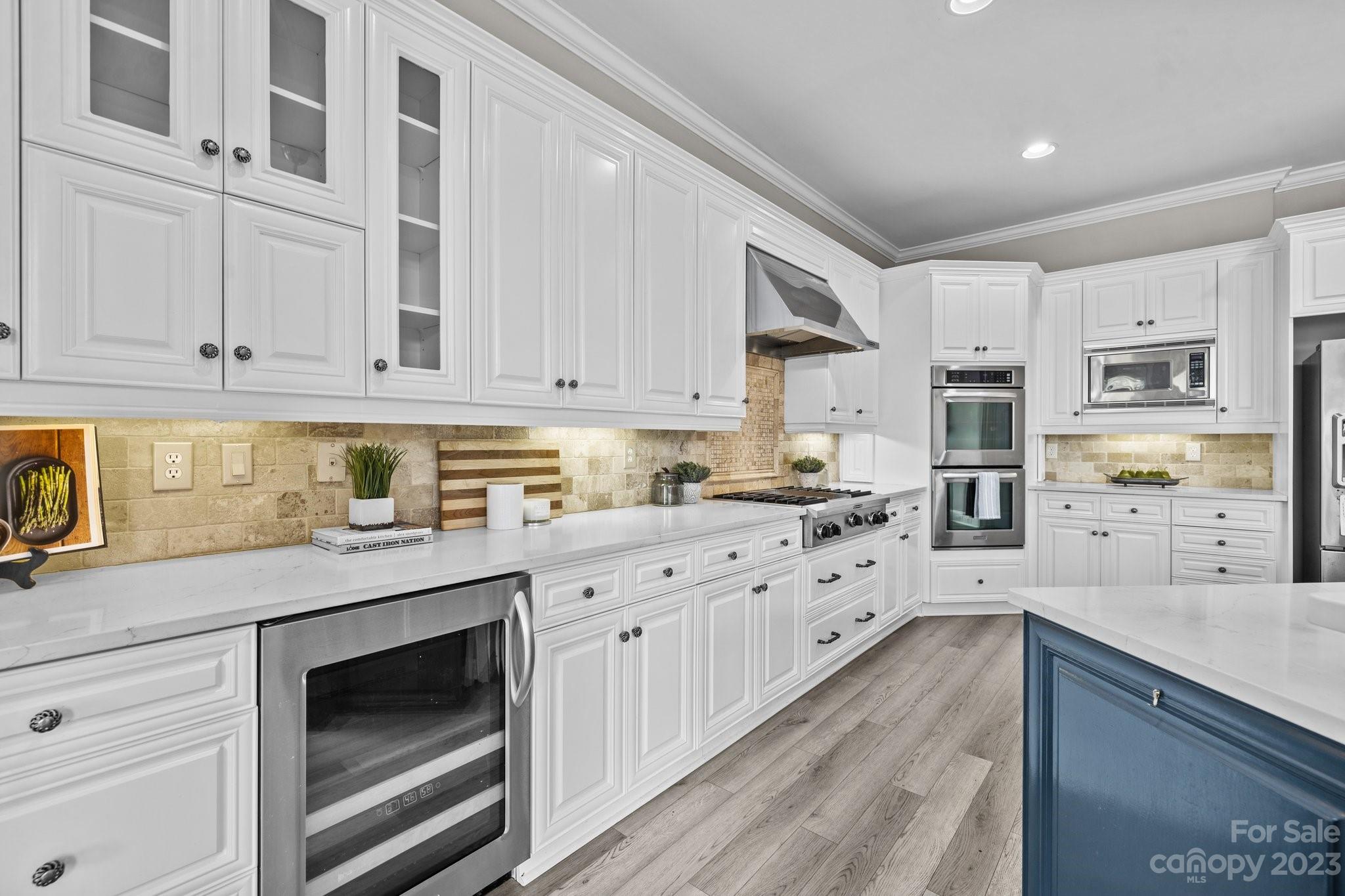 4732 Old Course Drive Charlotte, NC 28277 - Photo 21 of 48 a kitchen with granite countertop white cabinets and stainless steel appliances
