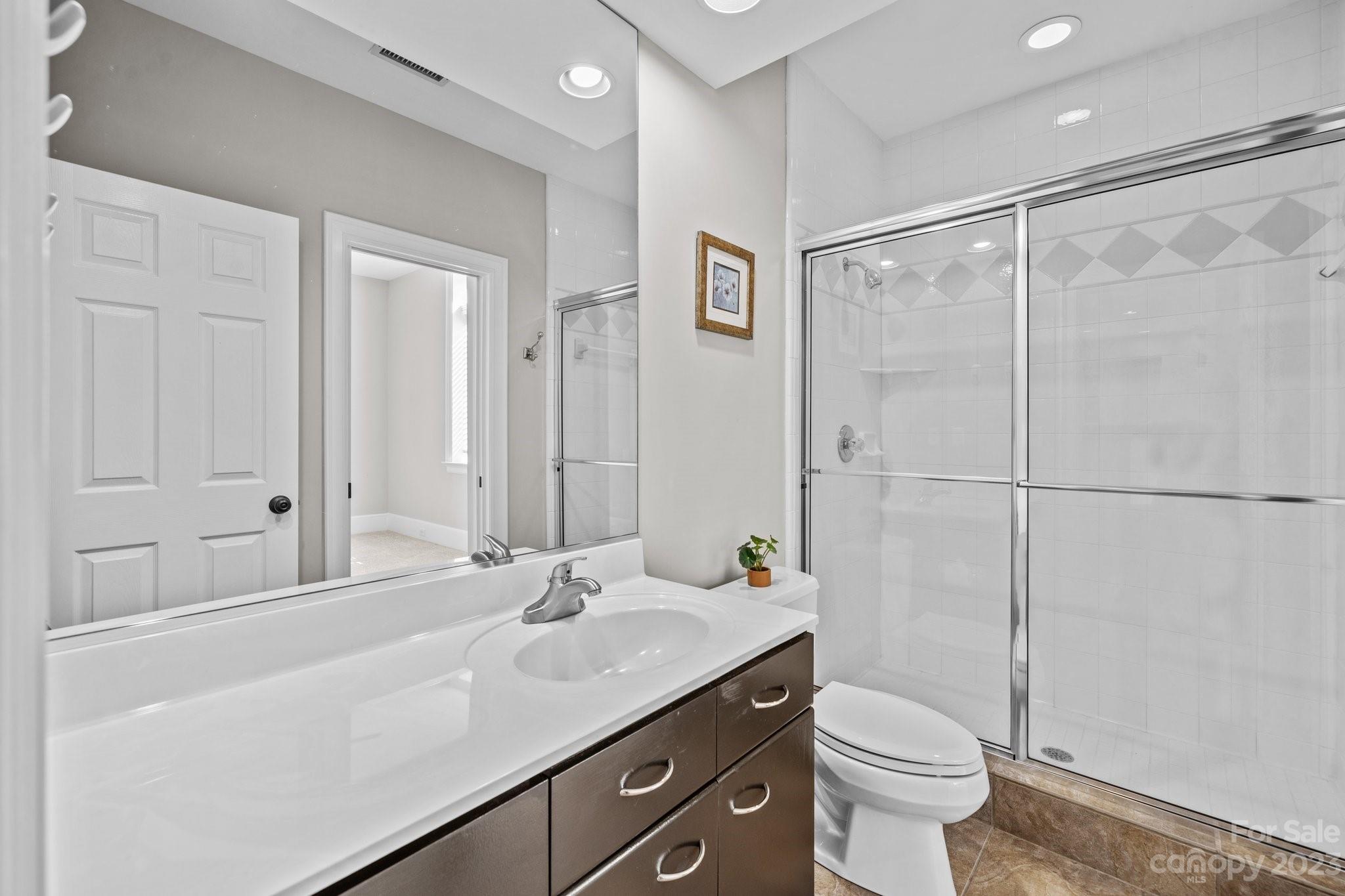 4732 Old Course Drive Charlotte, NC 28277 - Photo 28 of 48 a bathroom with a granite countertop sink a toilet and shower