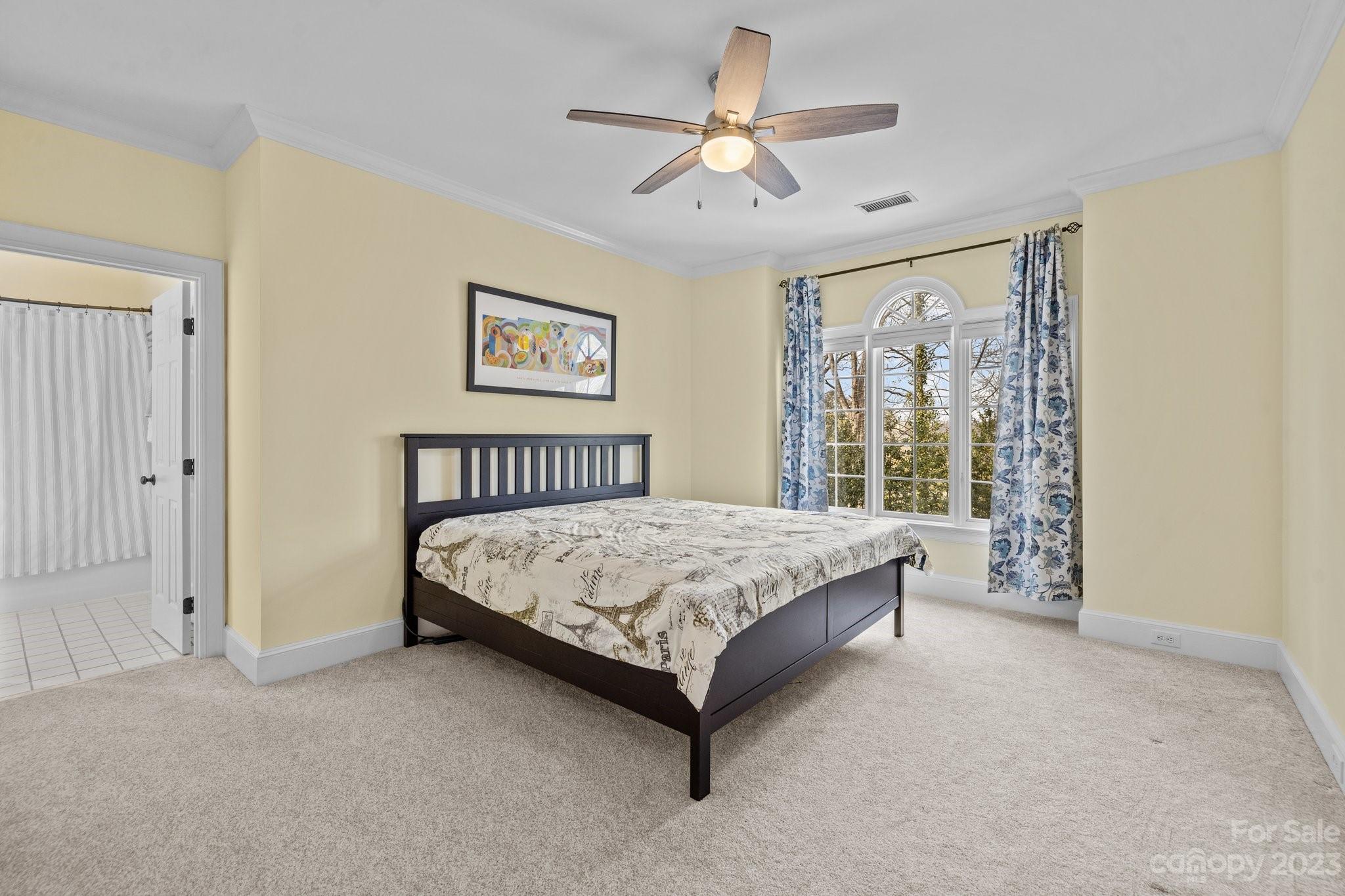 4732 Old Course Drive Charlotte, NC 28277 - Photo 31 of 48 a spacious bedroom with a large bed and a chandelier