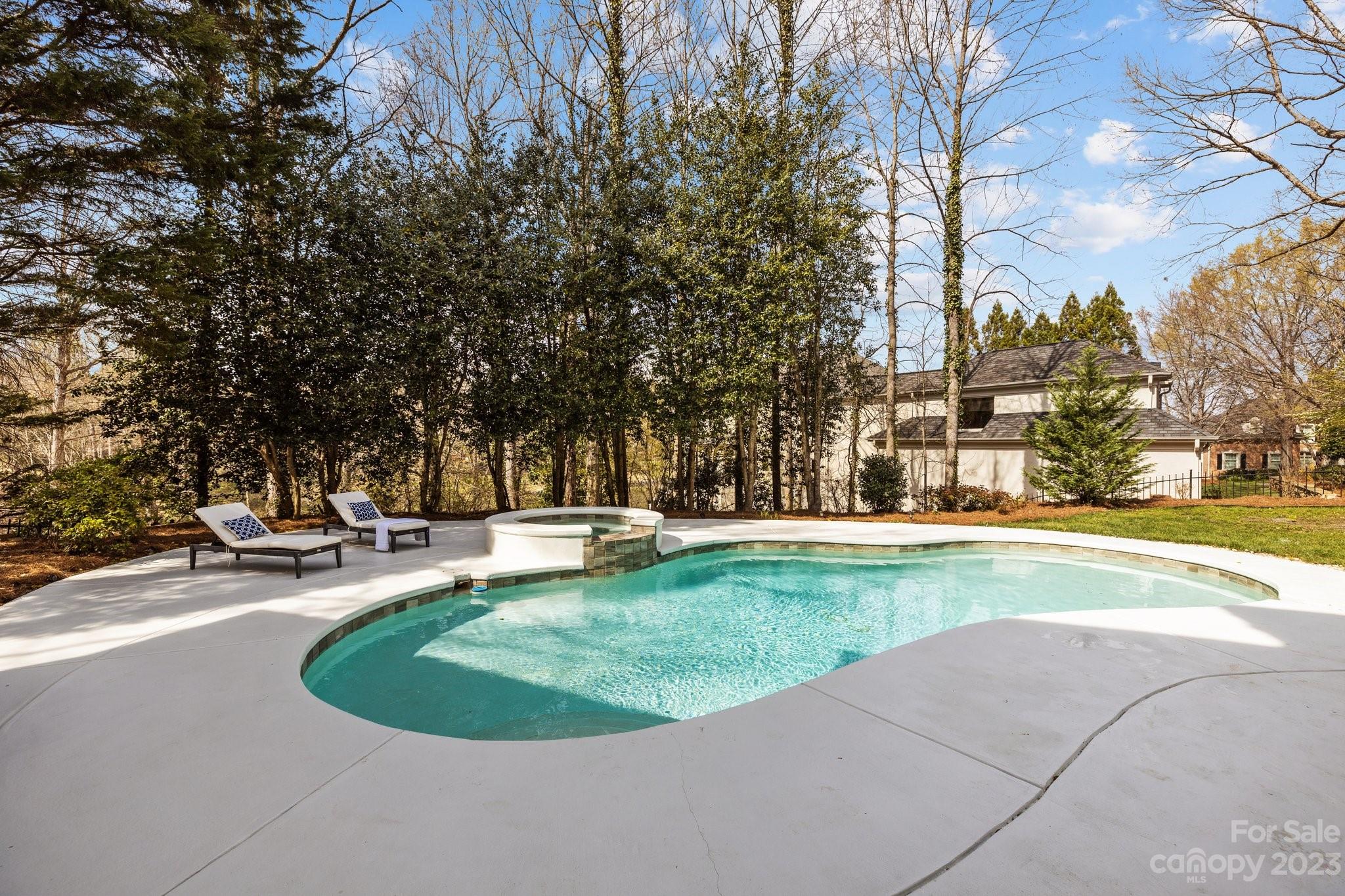 4732 Old Course Drive Charlotte, NC 28277 - Photo 5 of 48 a view of a swimming pool and trees in the background