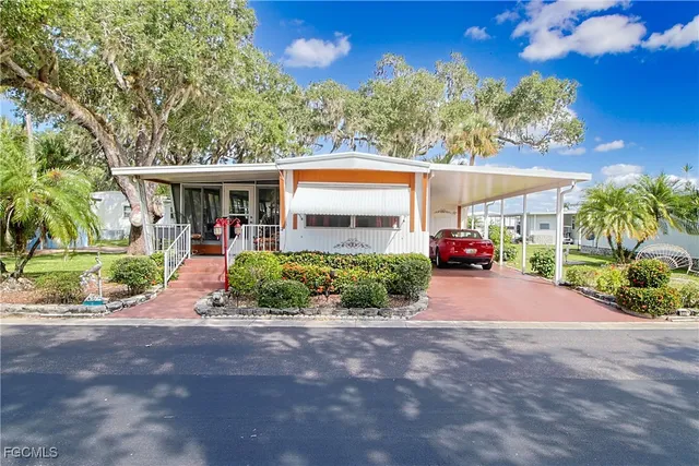 a front view of a house with a yard and outdoor seating