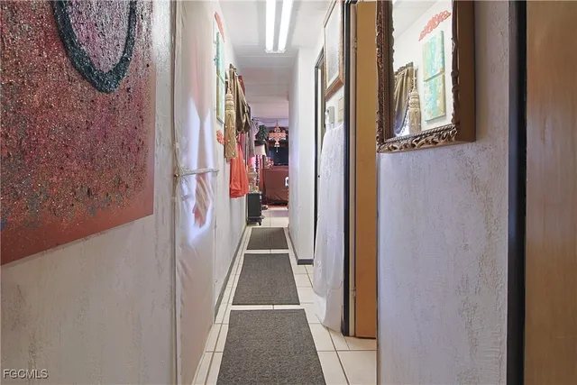 a view of a hallway with wooden floor and entryway