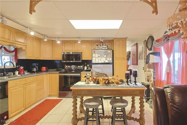 a kitchen with stainless steel appliances kitchen island granite countertop a sink and cabinets