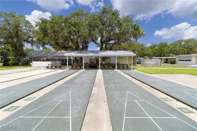 a view of house with yard and swimming pool