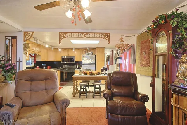 a living room with furniture a chandelier and a dining table