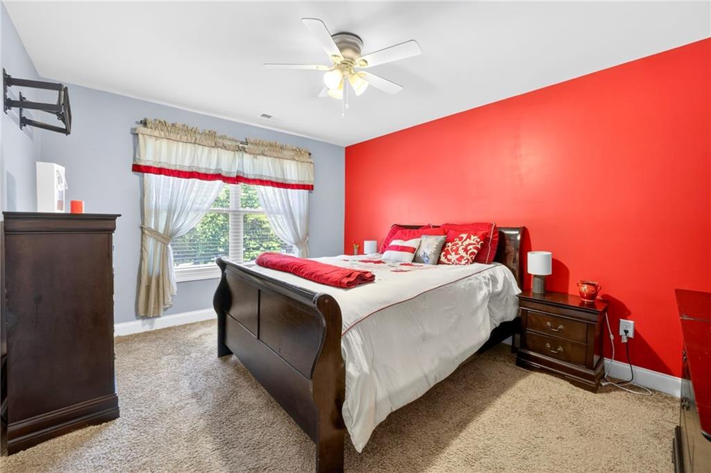 2300 Tucker Mill Road Southwest Conyers, GA 30094 - Photo 27 of 45 a bedroom with a bed and a chandelier