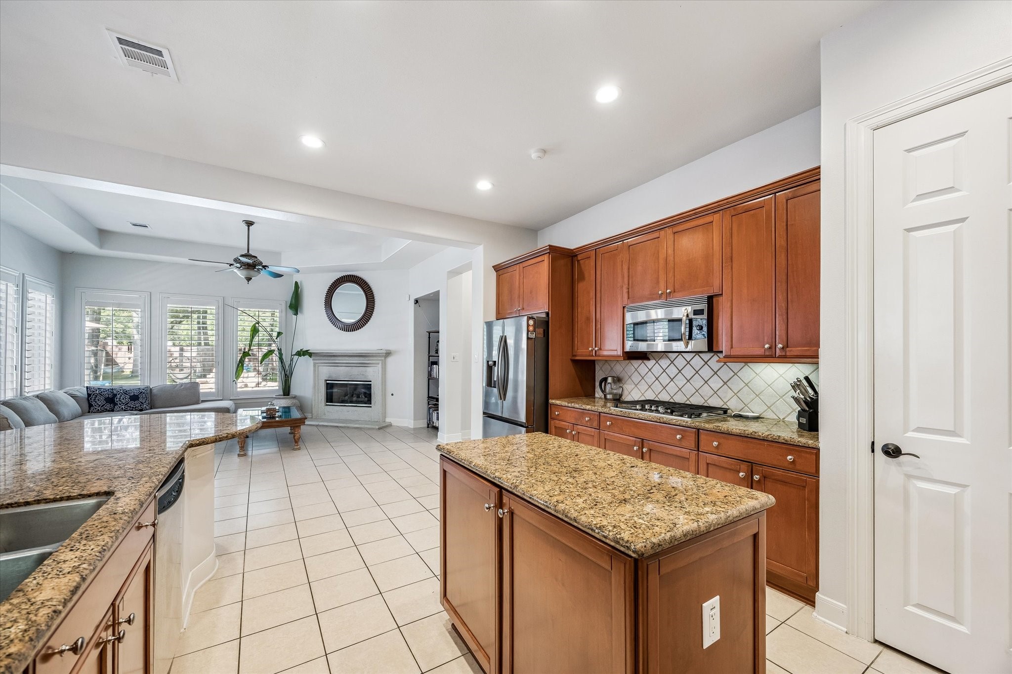 3047 Bonnebridge Way Boulevard Houston, TX 77082 - Photo 34 of 50 Chef’s dream kitchen featuring expansive granite countertops, abundant cabinetry for storage, and a large central island perfect for meal preparation and entertaining.