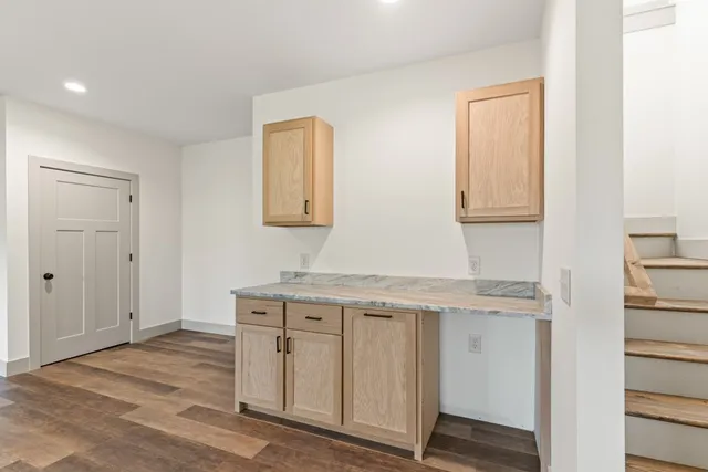 a view of hallway with wooden floor