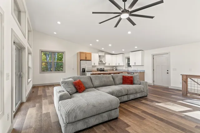 a living room with furniture and kitchen view