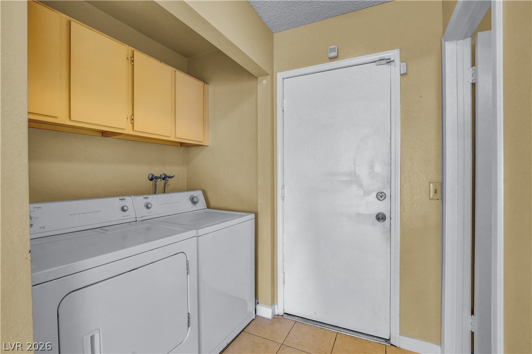 6440 Hartwood Road Las Vegas, NV 89108 - Photo 23 of 59 Functional laundry space featuring convenient upper cabinetry and durable tile flooring.