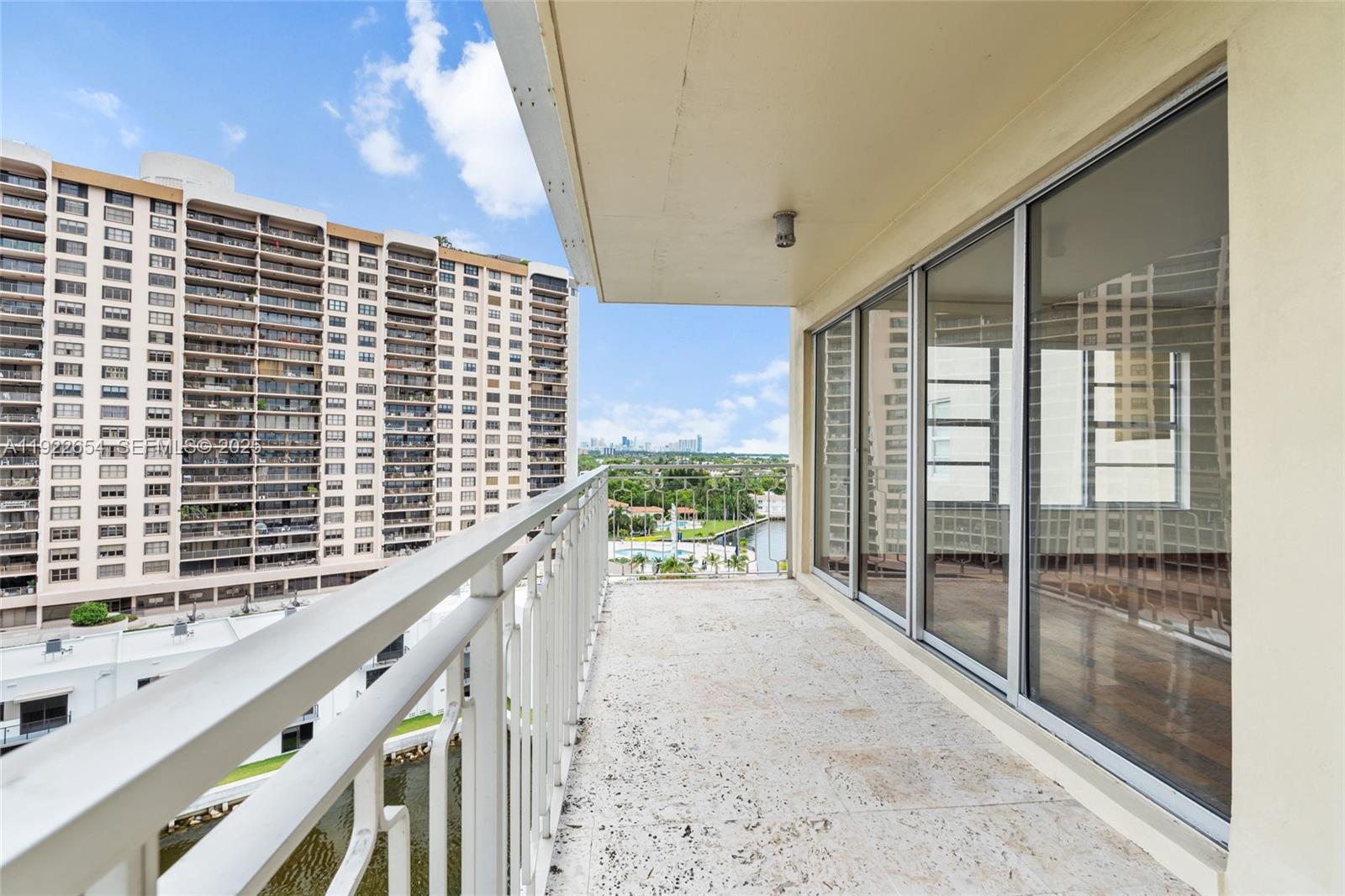 11111 Biscayne Boulevard, Unit 10H Miami, FL 33181 - Photo 12 of 22 a view of balcony with floor to ceiling windows and wooden floor
