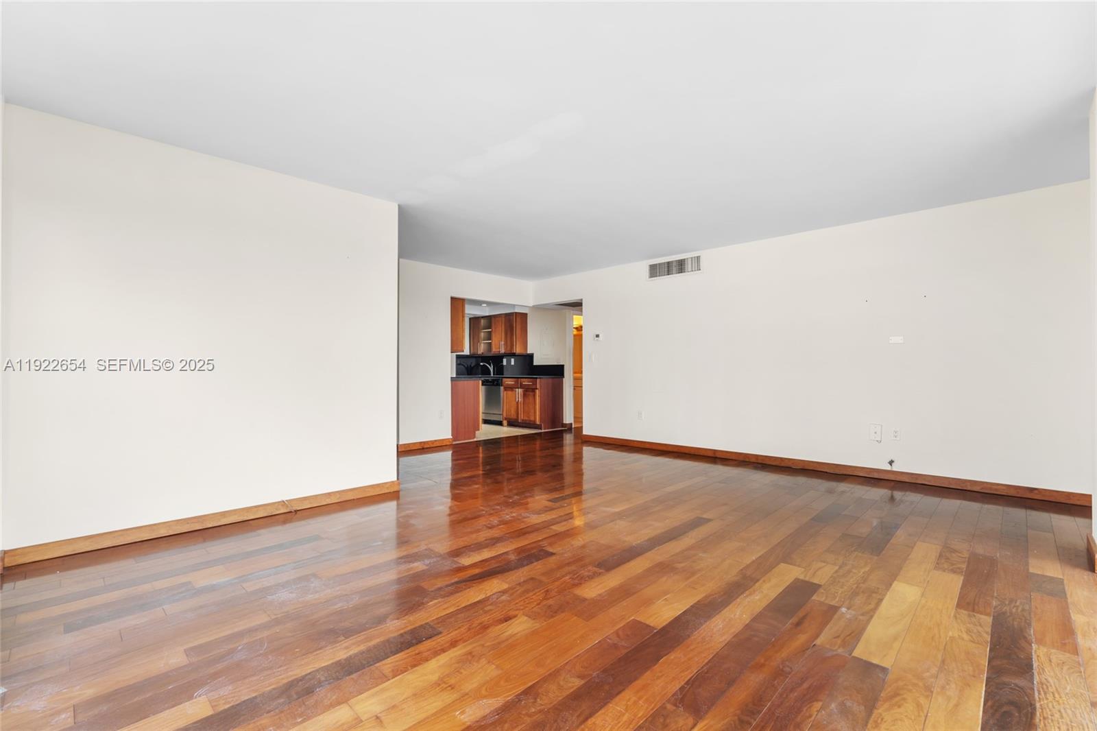 11111 Biscayne Boulevard, Unit 10H Miami, FL 33181 - Photo 4 of 22 a view of empty room with wooden floor