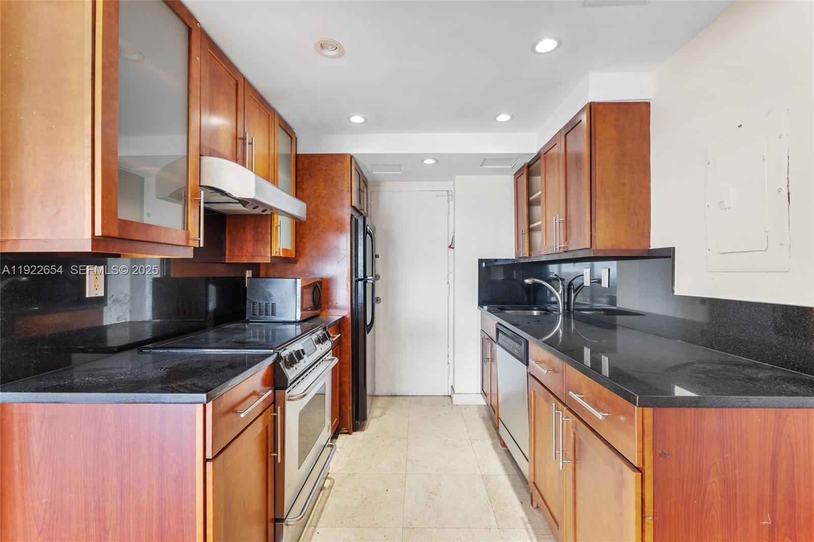11111 Biscayne Boulevard, Unit 10H Miami, FL 33181 - Photo 5 of 22 a kitchen with stainless steel appliances granite countertop a sink a stove and a refrigerator
