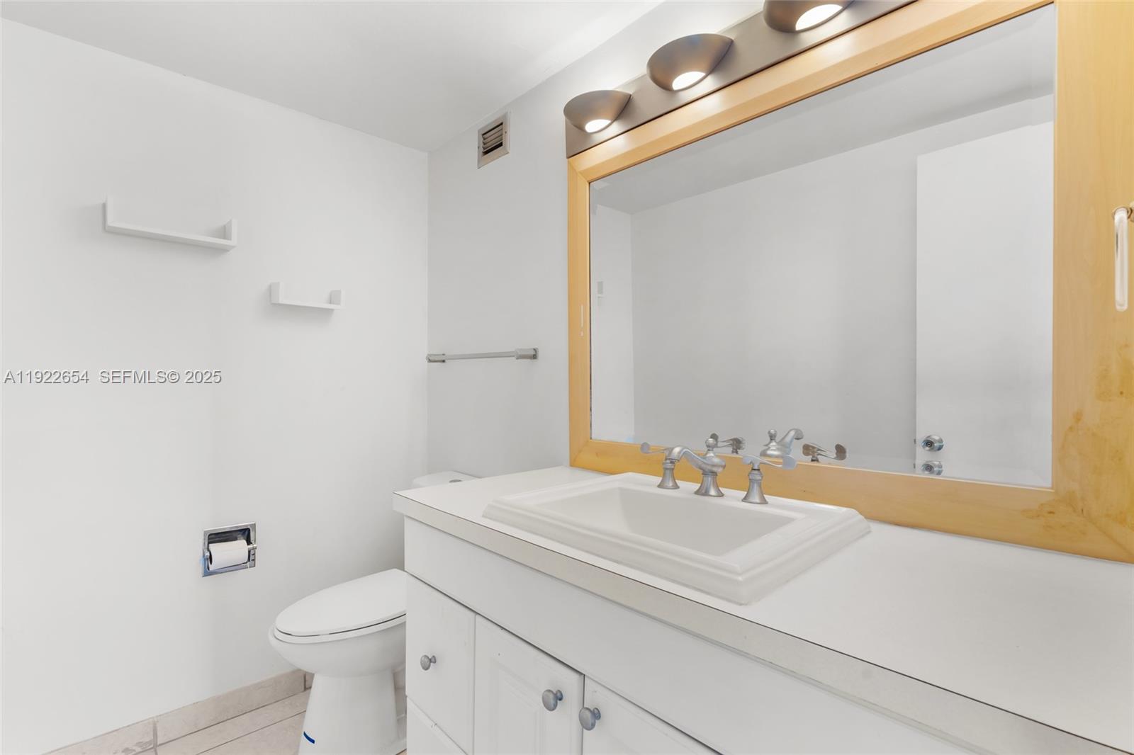 11111 Biscayne Boulevard, Unit 10H Miami, FL 33181 - Photo 8 of 22 a bathroom with a sink and a toilet