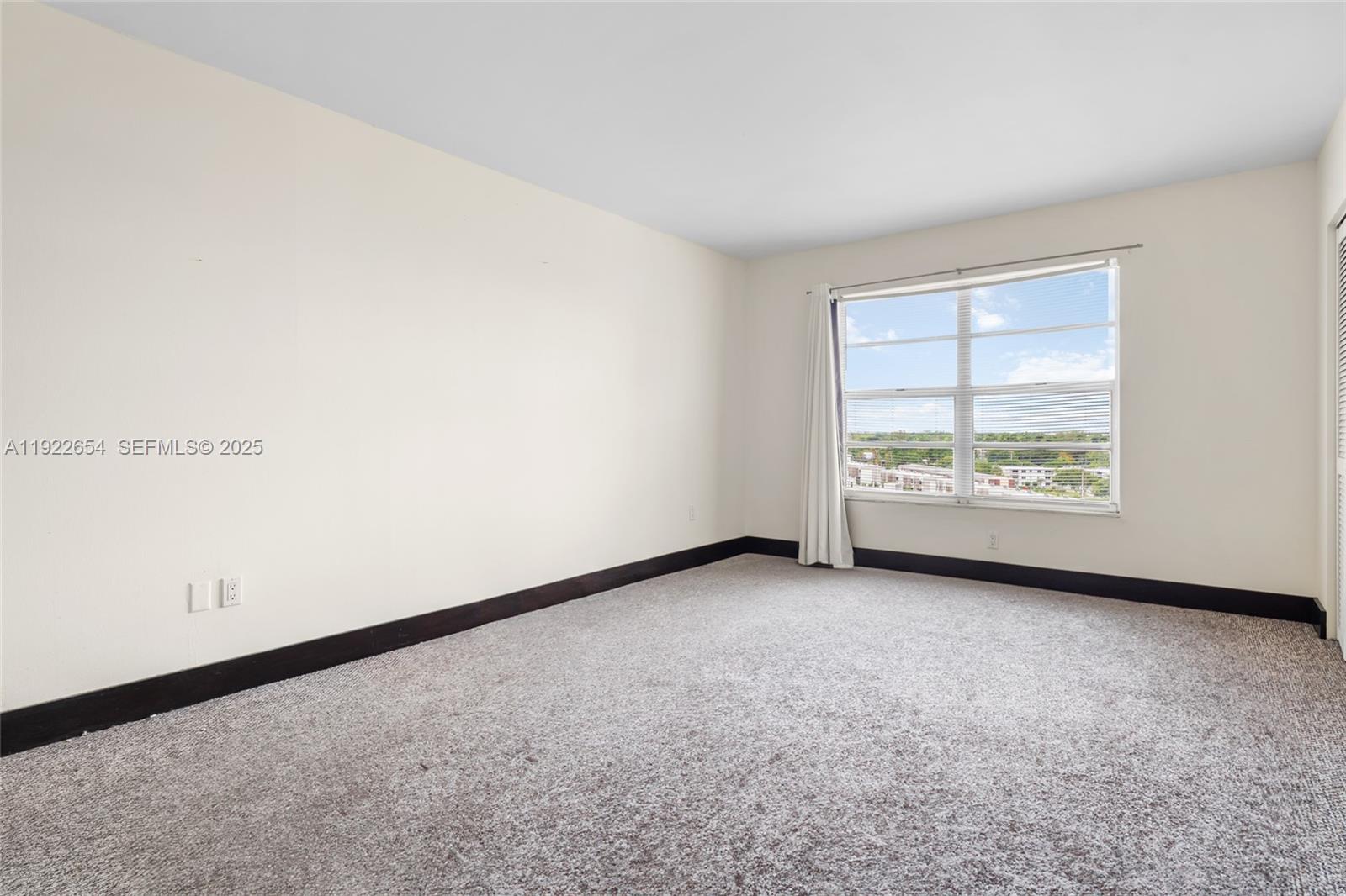 11111 Biscayne Boulevard, Unit 10H Miami, FL 33181 - Photo 9 of 22 an empty room with large window