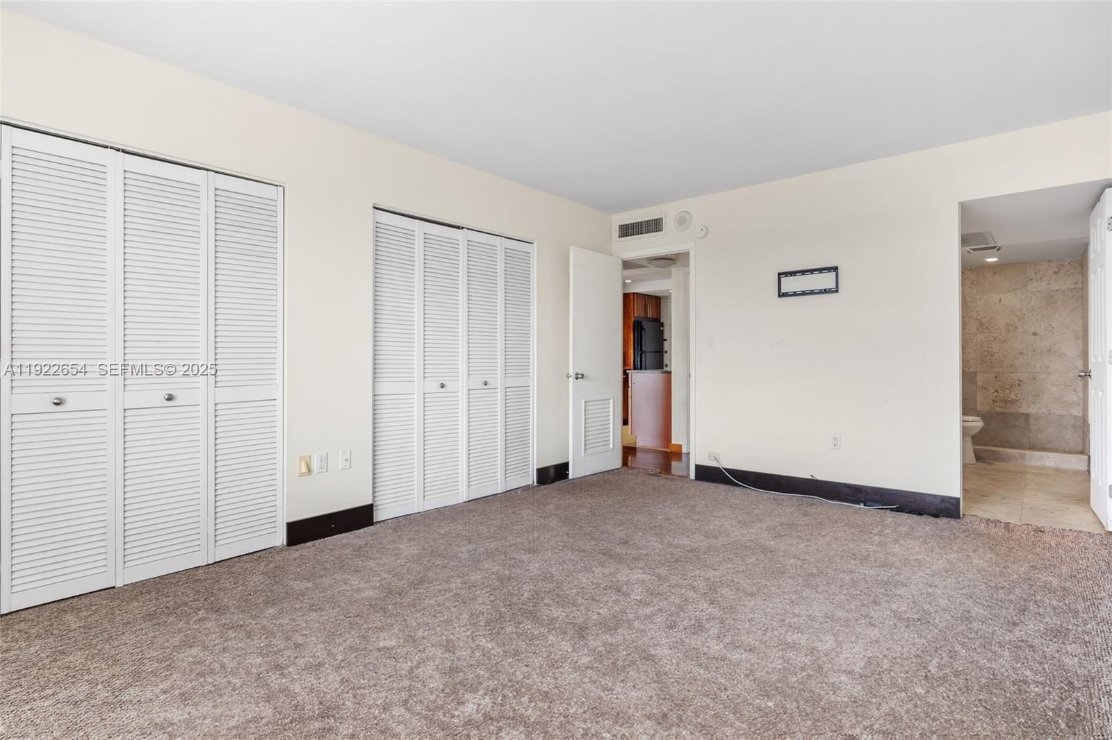 11111 Biscayne Boulevard, Unit 10H Miami, FL 33181 - Photo 10 of 22 an empty room with closet area