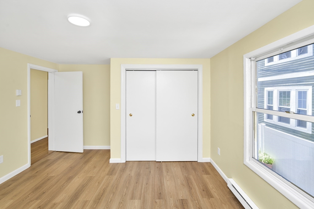 11 Greendale Road, Unit 2 Boston, MA 02126 - Photo 21 of 25 wooden floor in an empty room with a window