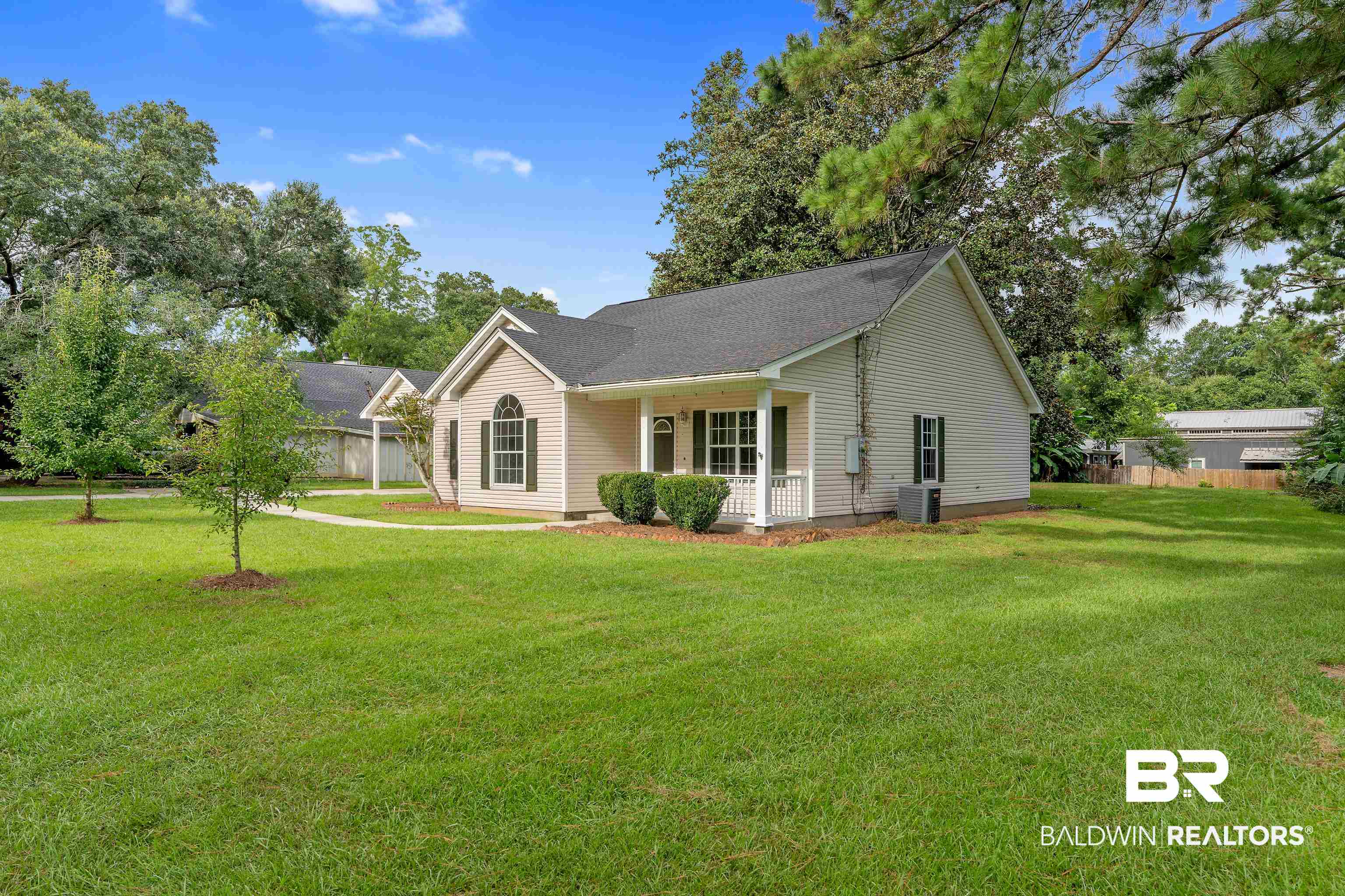 20525 Lawrence Road Fairhope, AL 36532 - Photo 22 of 26 View of property exterior featuring central air condition unit and a lawn
