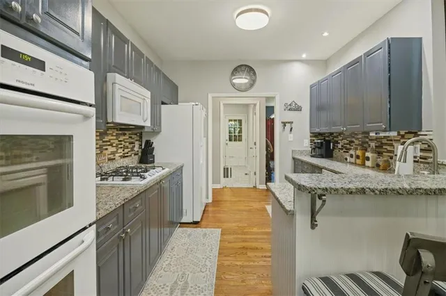 a kitchen with granite countertop a sink and stove