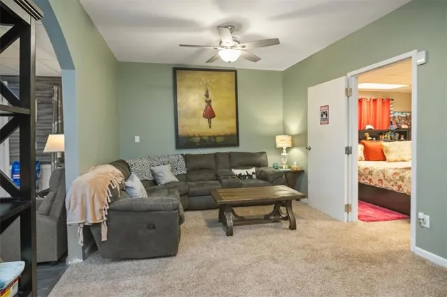 a living room with furniture and a chandelier