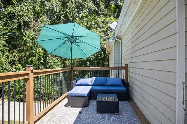 a view of a patio with furniture under an umbrella