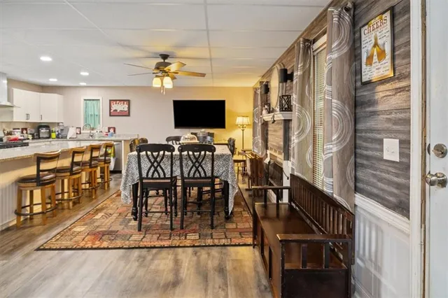 a view of a dining room with furniture a chandelier and wooden floor