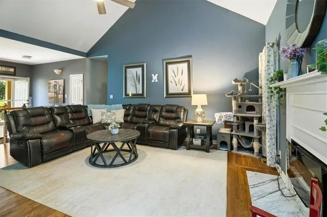 a living room with furniture a fireplace and a flat screen tv